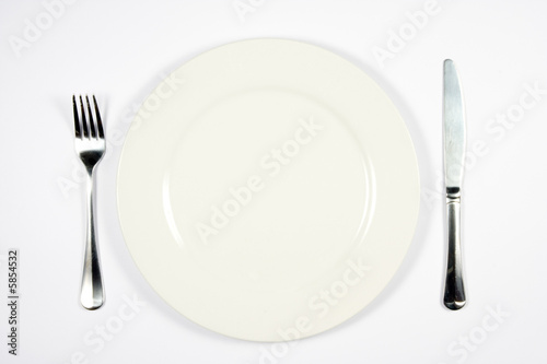 A place setting for dinner against white background