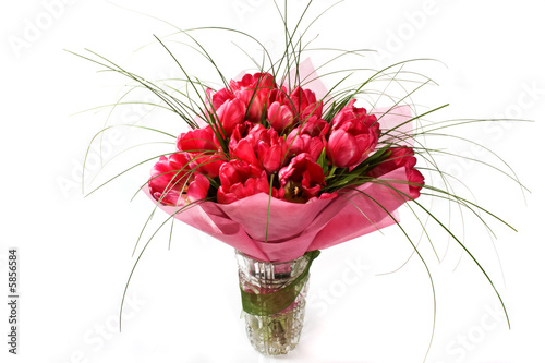 Bouquet of tulips in the crystal vase. Isolated on white.