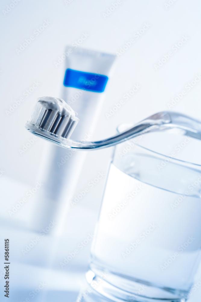 Toothbrush, toothpaste and glass of water on table Toothbrush, toothpaste and glass of water on table