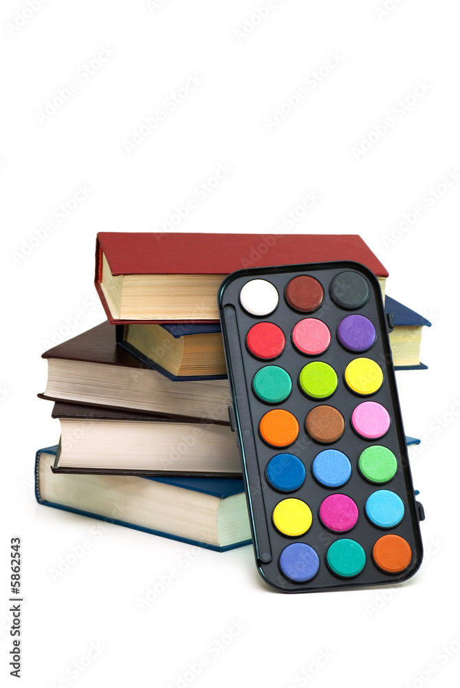 Watercolour palette and stack of books on white Watercolour palette and stack of books on white