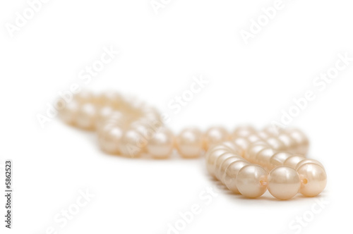 Pearl necklace on white - shallow depth of field