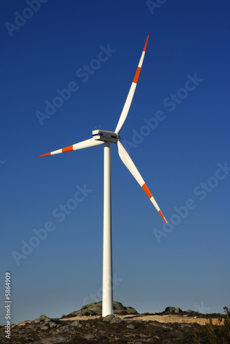 Modern white wind turbine or wind mill producing energy photo