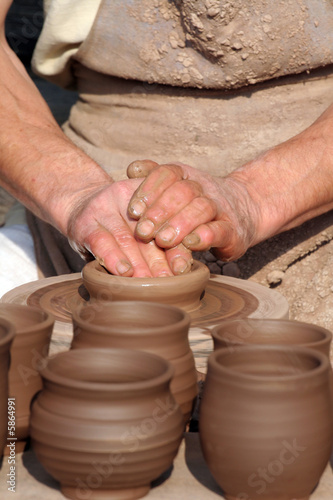 Hands of a man making cups