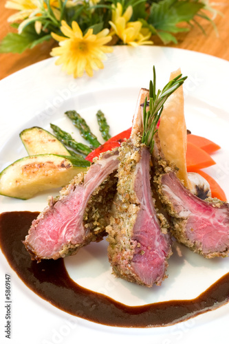 Crusted lamb chops served with zucchini and peppers