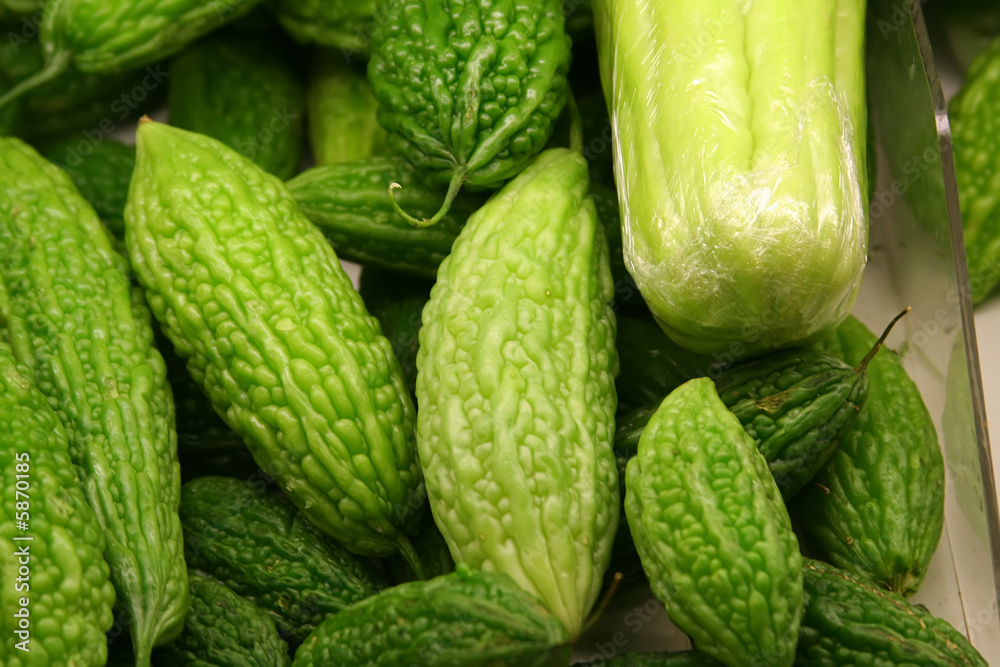 A tray of bitter gourds in a market. A tray of bitter gourds in a market.