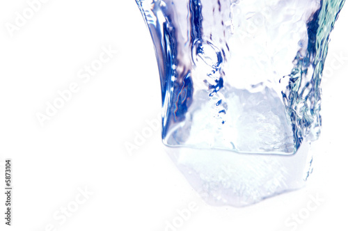 Ice cube fall on white background .