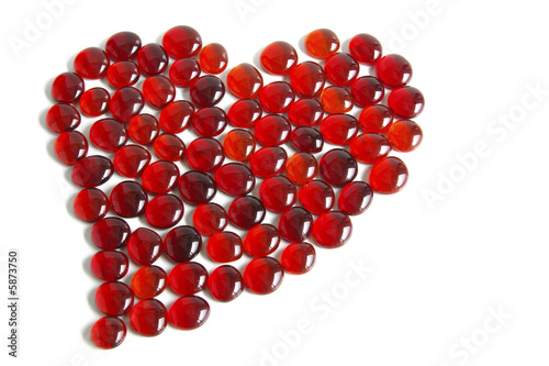 Photo of tens of little red glass gems forming a heart