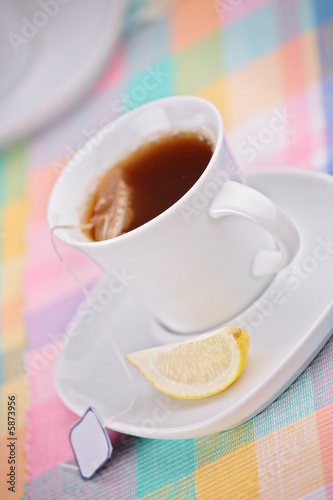 A view of a cup of tea and a slice of lemon
