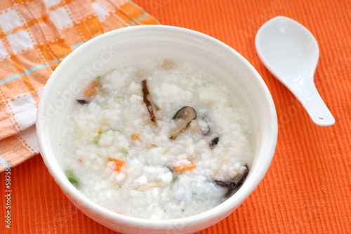 Chinese dimsum porridge with sliced mushrooms and vegetables