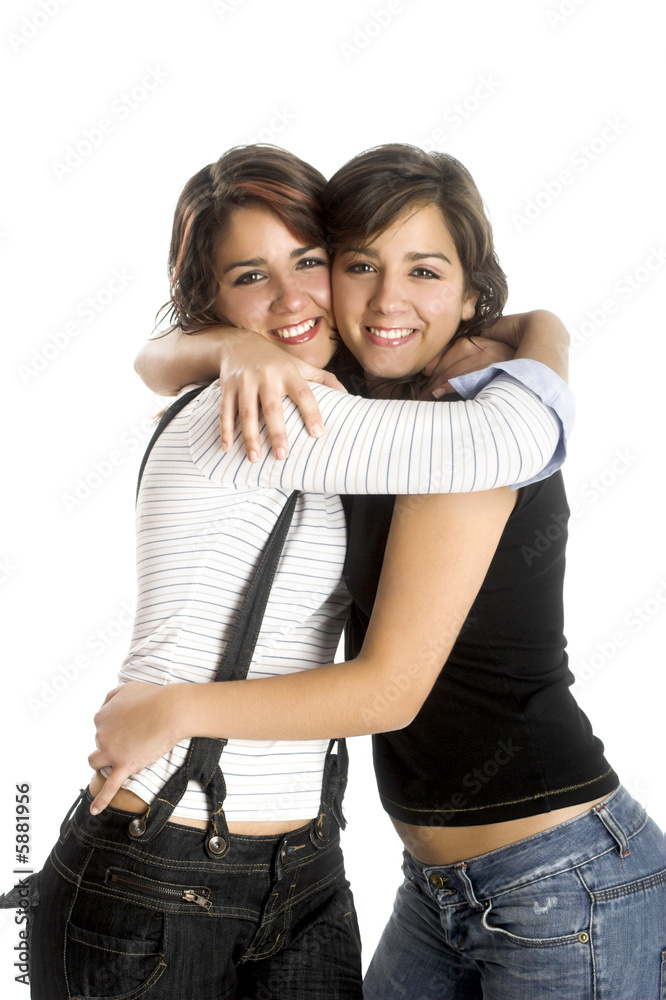 Two young beautiful sisters having fun isolated on white Two young beautiful sisters having fun isolated on white