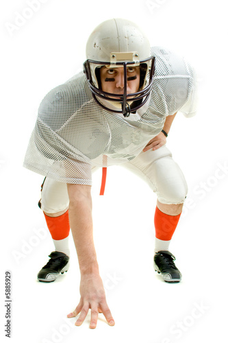 An American football player. Three point stance.