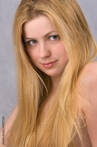 close-up portrait of blond young gray-eyed woman