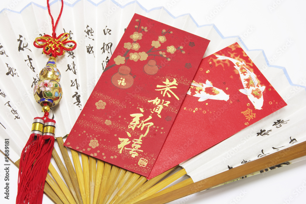 Fototapeta premium Red Packets and Trinket on Paper Fan
