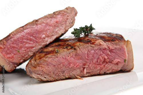 Rare sirloin steak resting on a white plate