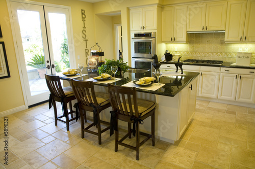 Modern kitchen with tile floor and island.