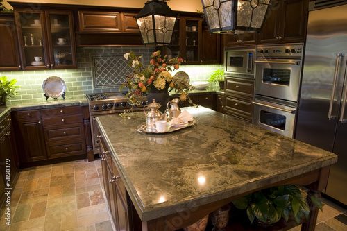 Modern Kitchen with brown tiles.