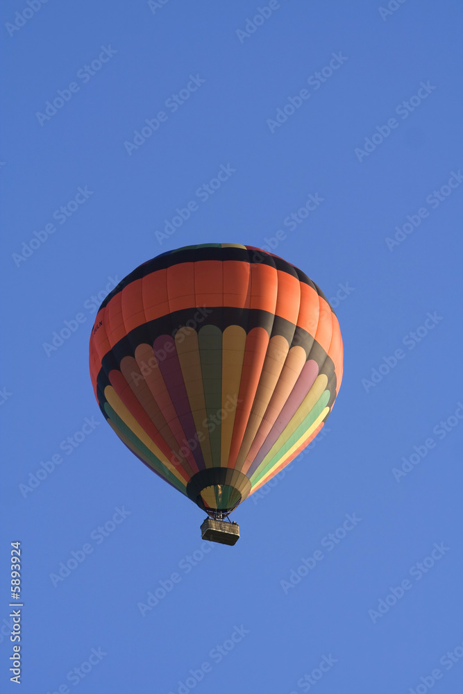 Hot air balloon flying in blue sky Hot air balloon flying in blue sky