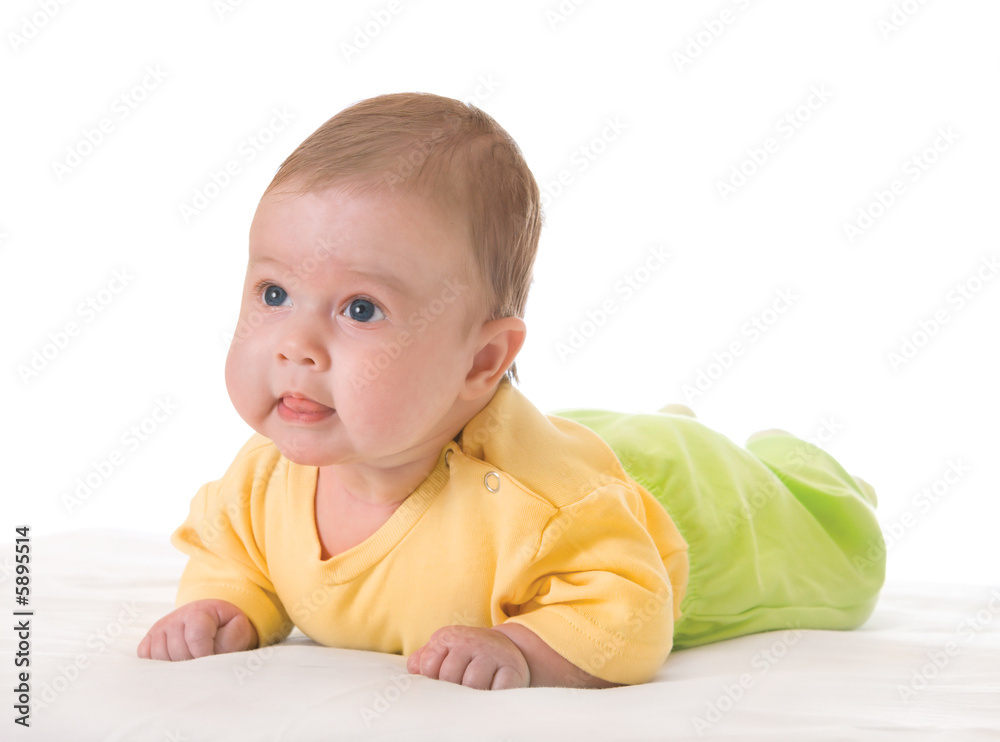 Smiling baby on bed over white Smiling baby on bed over white