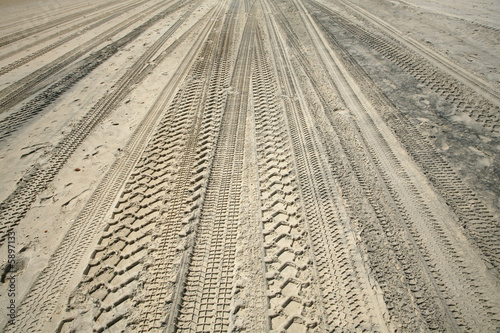 trace cars on the sand of the beach