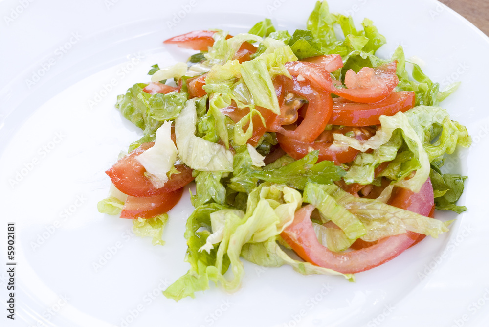 Salad from tomatoes and fresh lettuce with green Salad from tomatoes and fresh lettuce with green