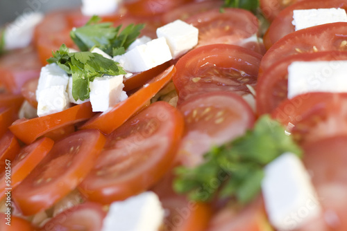 Light snack from tomatoes with soft cheese and green