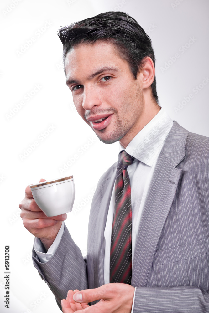handsome businessman is drinking coffee from a cup handsome businessman is drinking coffee from a cup