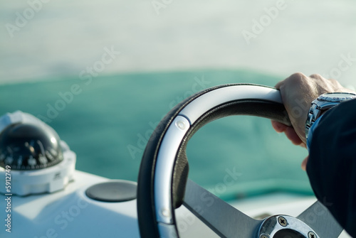 a hand with a steering wheel rudder © Javier Pazo