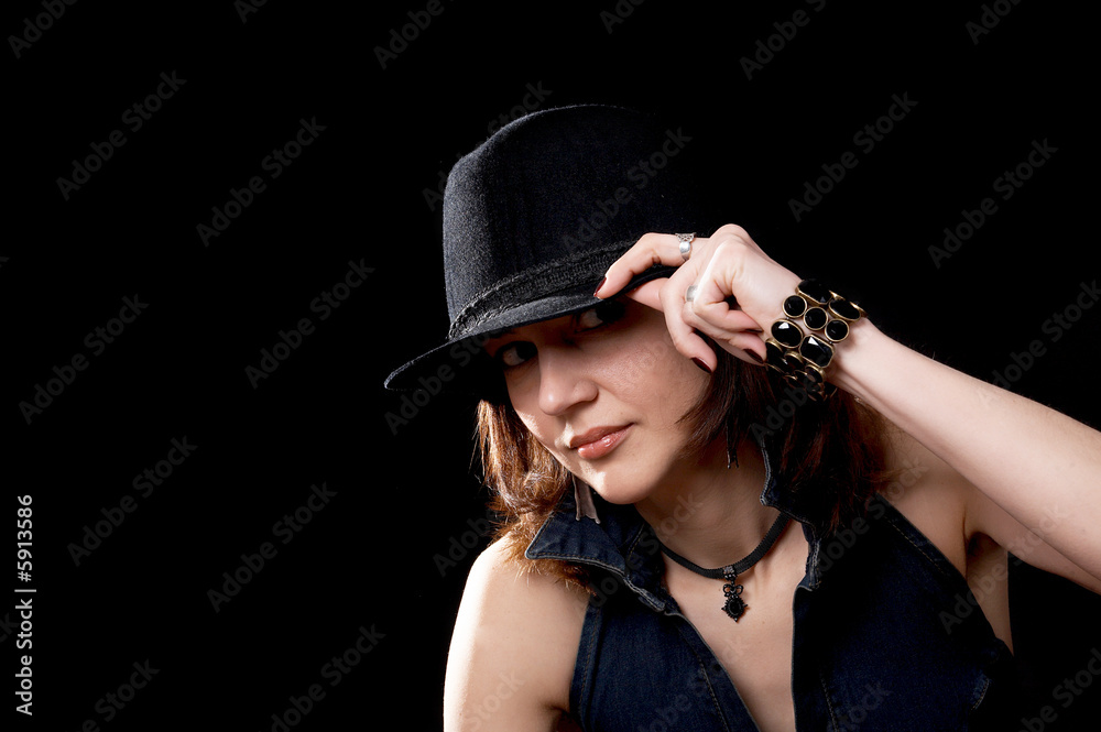 Young woman in hat isolated on the black background Young woman in hat isolated on the black background
