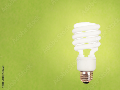 compact fluorescent bulb on green background