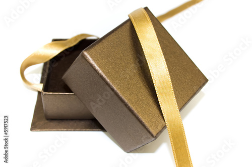 Open gift box with gold ribbon isolated on white