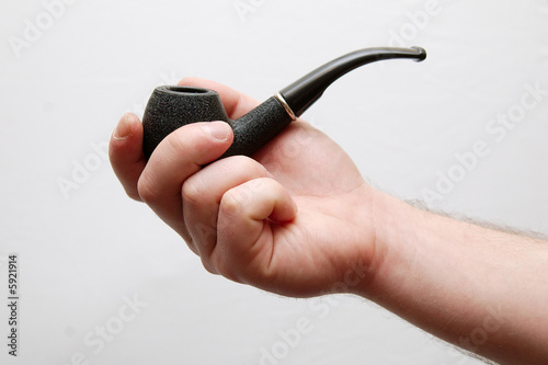 Hands holding tobacco-pipe