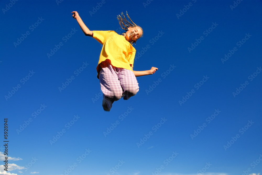 Teen girl jumping in air