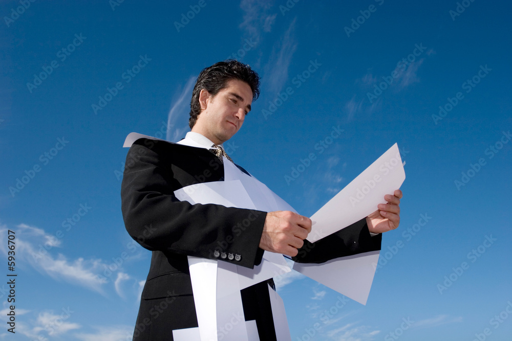 Busy businessman looking over paperwork