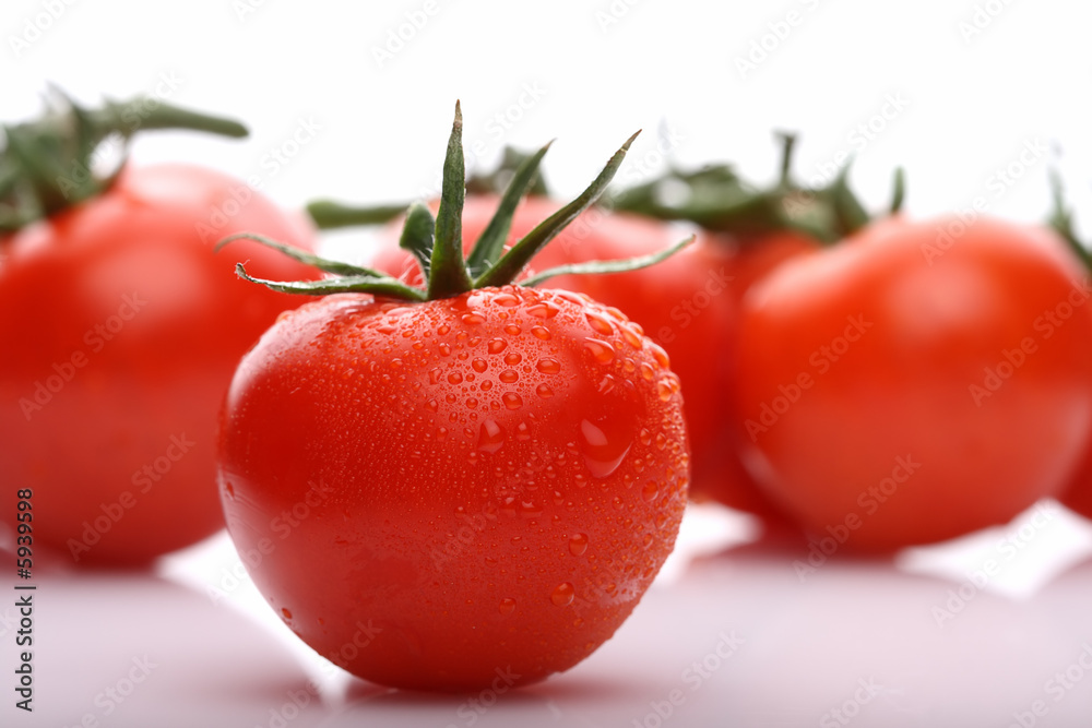 perfect red tomato with tomatoes on background perfect red tomato with tomatoes on background
