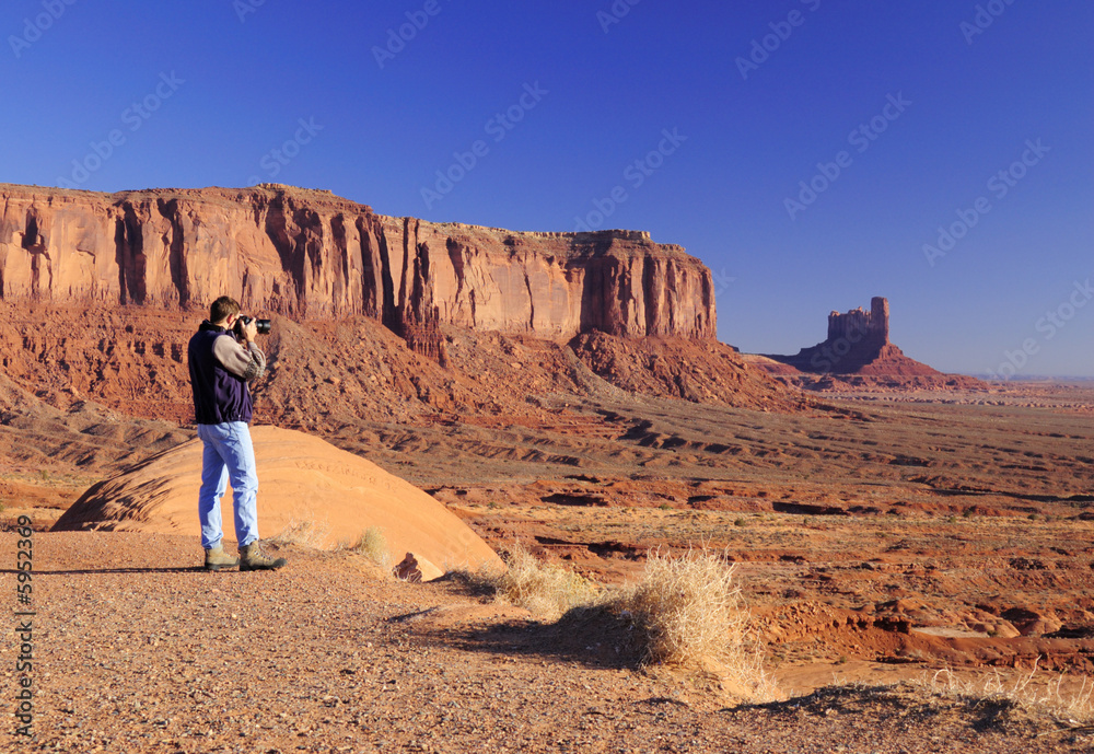 Young male is photographing Monument Valley 