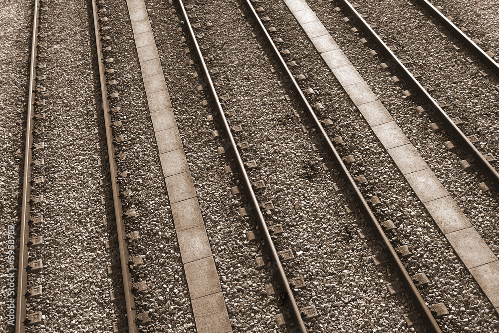 Three parallel railway tracks toned in sepia color Three parallel railway tracks toned in sepia color