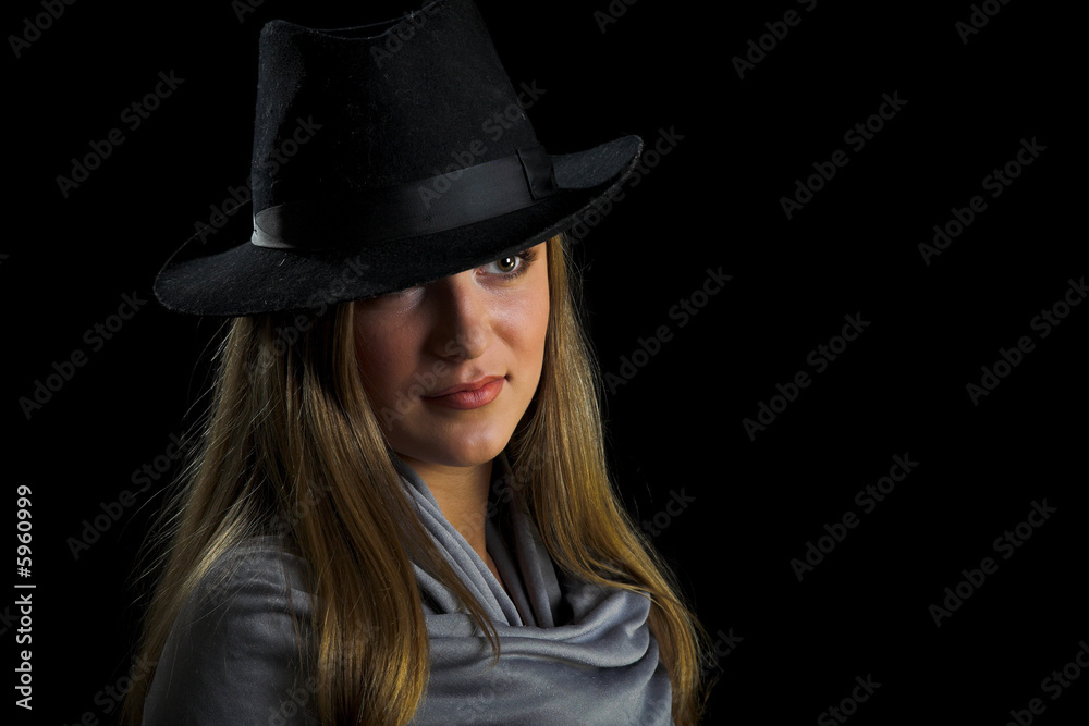 young woman in black hat on black young woman in black hat on black