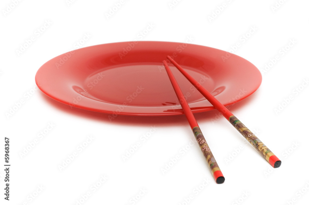 Red plate and chopsticks isolated on the white