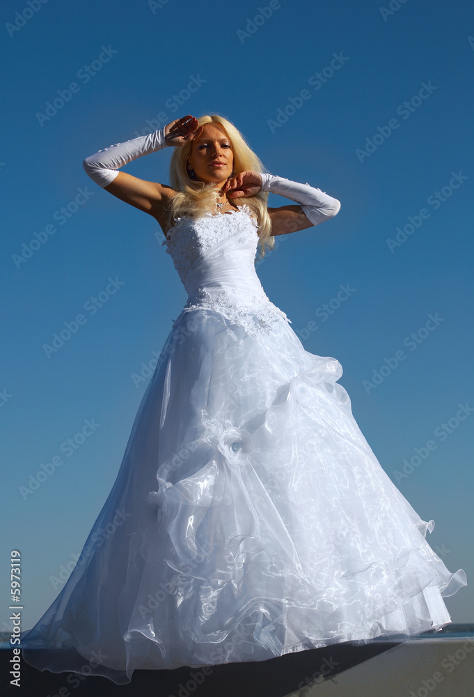 Blonde bride on blue sky background Blonde bride on blue sky background