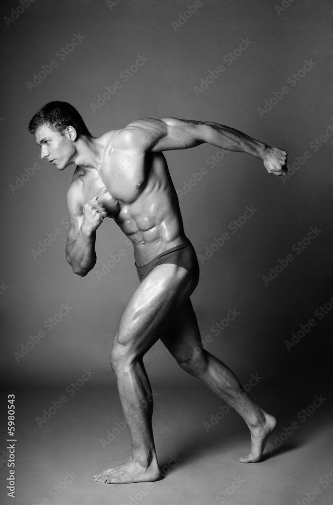 Fototapeta premium Sport and health body of young man. Isolated on white.