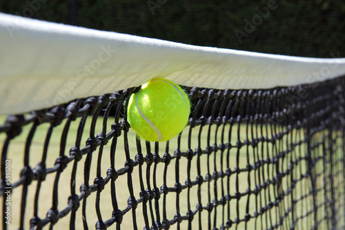 Tennis ball in net. © S.White