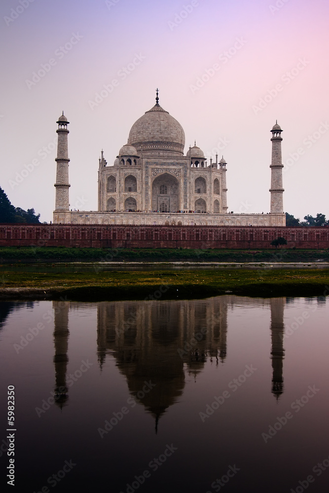 Fototapeta premium The Taj Mahal mausoleum reflecting in the Yamuna river
