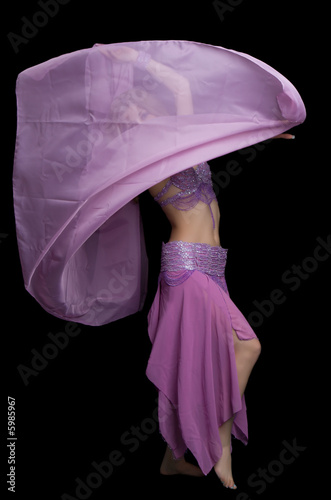 Tableau sur toile Attractive girl dances east dance isolated on a black background