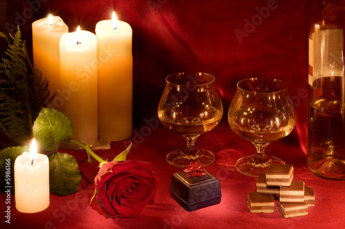 Valentine dinner with rose, candles, gift box and candies