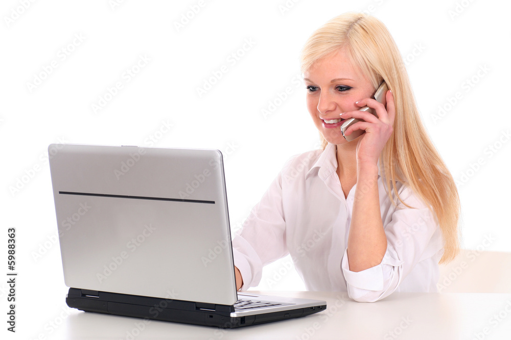Woman talking on cell phone and using laptop Woman talking on cell phone and using laptop