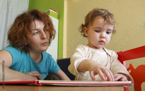 A mother is teaching her child.