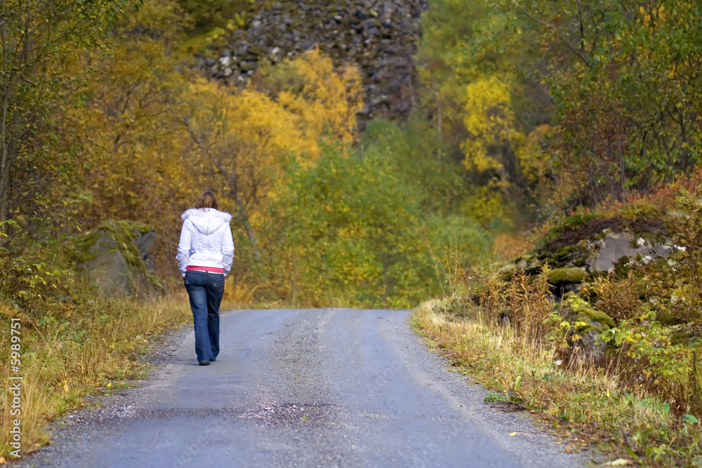 woman walking alone in forest in autumn woman walking alone in forest in autumn