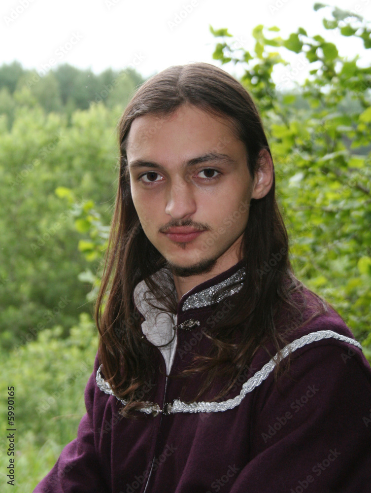 Portrait of the romantic youth in summer forest Portrait of the romantic youth in summer forest