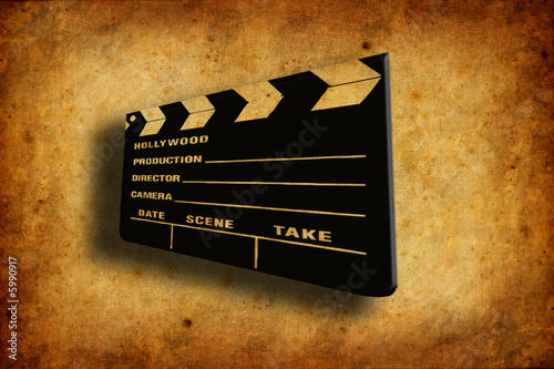 cinema clapboard over old and worn paper texture
