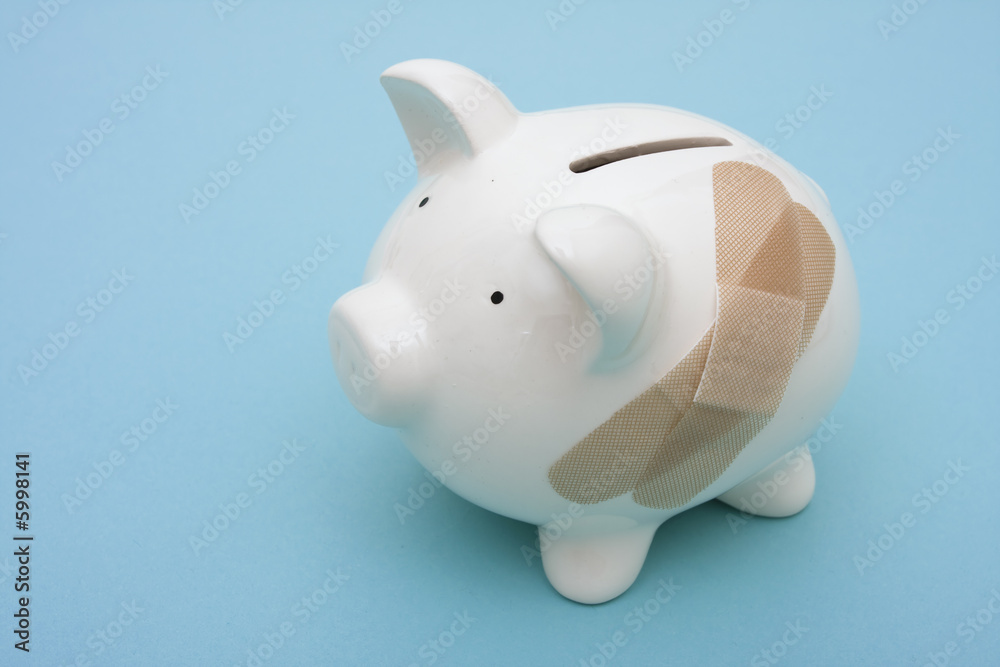 Piggy bank with adhesive bandage with copy space Piggy bank with adhesive bandage with copy space